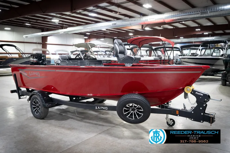 Slide: The Image of 2026 Lund 1800 Explorer Sport boat in showroom, red exterior, on trailer. - 5