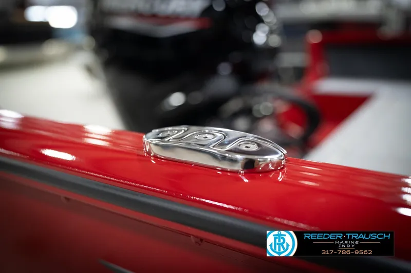 Slide: The Image of 2026 Lund 1800 Explorer Sport boat detail with red finish and chrome hardware. - 51
