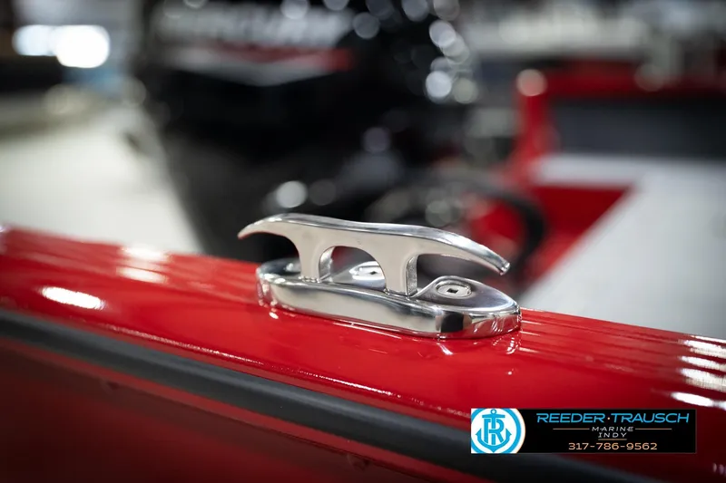 Slide: The Image of 2026 Lund 1800 Explorer Sport boat cleat on red surface, Reeder-Trausch Marine logo visible. - 52