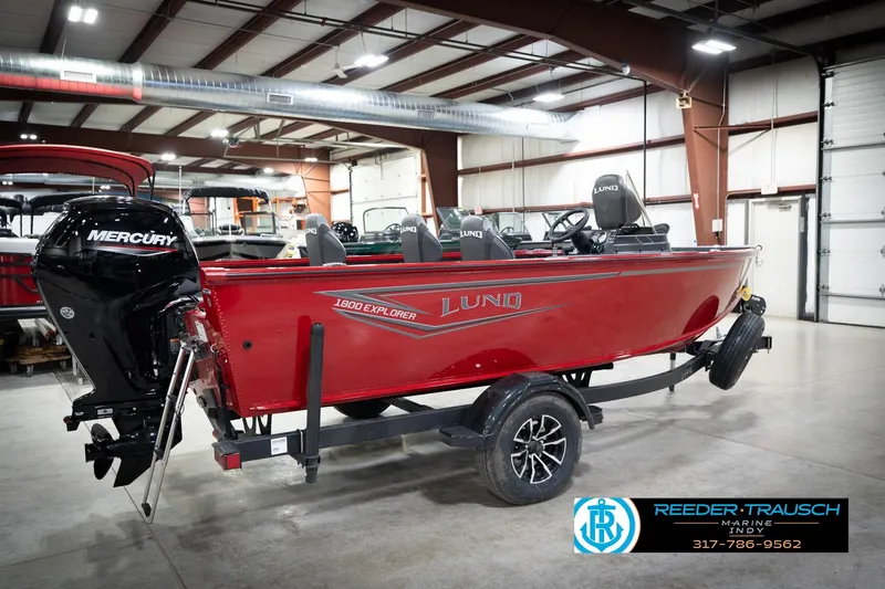 Slide: The Image of 2026 Lund 1800 Explorer Sport boat in a showroom, featuring a Mercury engine. - 7