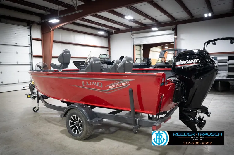 Slide: The Image of 2026 Lund 1800 Explorer Sport boat in a showroom with Mercury engine. - 9