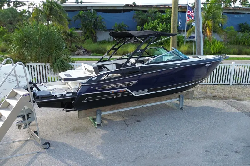 Slide: The Image of 2021 Monterey 275 Super Sport boat on display, sleek design, parked outdoors. - 1