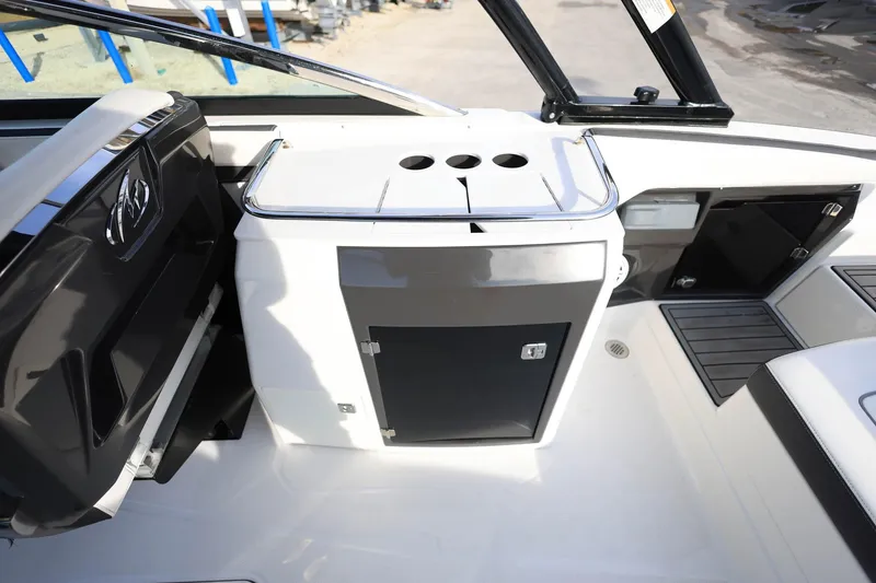 Slide: The Image of Interior view of a 2021 Monterey 275 Super Sport boat, featuring sleek cabinetry and seating. - 21