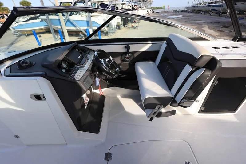 Slide: The Image of 2021 Monterey 275 Super Sport boat interior with sleek dashboard and comfortable seating. - 22