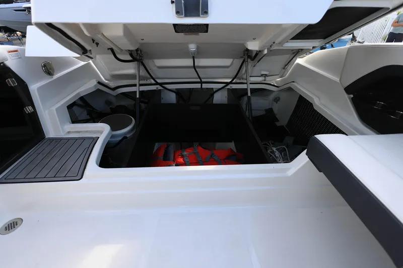 Slide: The Image of Open storage compartment in 2021 Monterey 275 Super Sport boat, featuring life jackets and equipment. - 28