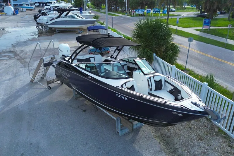 Slide: The Image of 2021 Monterey 275 Super Sport boat on display at a marina, featuring sleek design. - 3