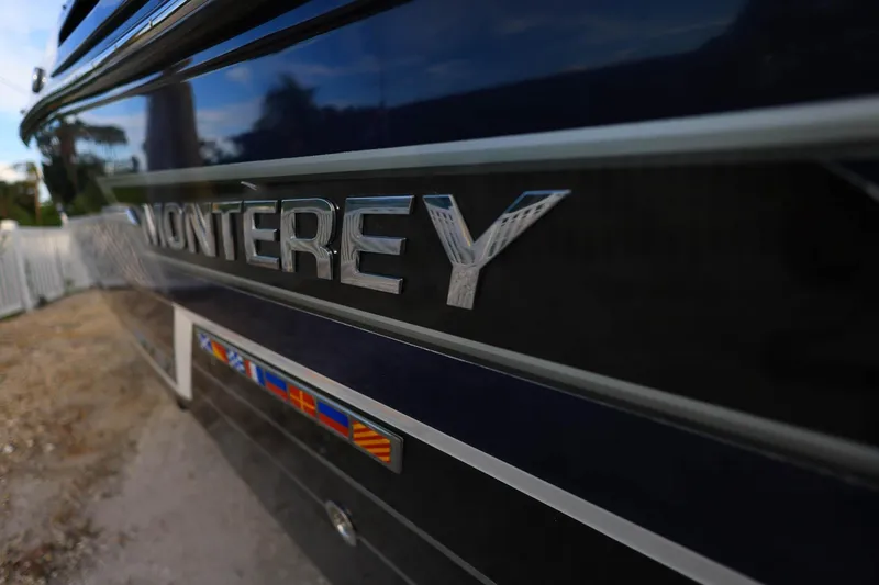 Slide: The Image of 2021 Monterey 275 Super Sport boat with sleek design and vibrant emblem. - 30