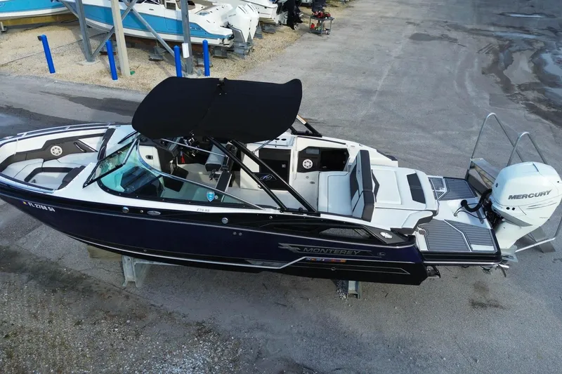Slide: The Image of 2021 Monterey 275 Super Sport boat with Mercury engine, docked on a dry surface. - 5