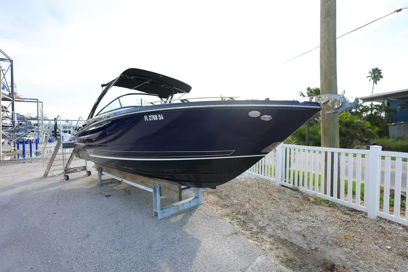 Slide: The Image of 2021 Monterey 275 Super Sport boat on trailer, parked near marina. - 6