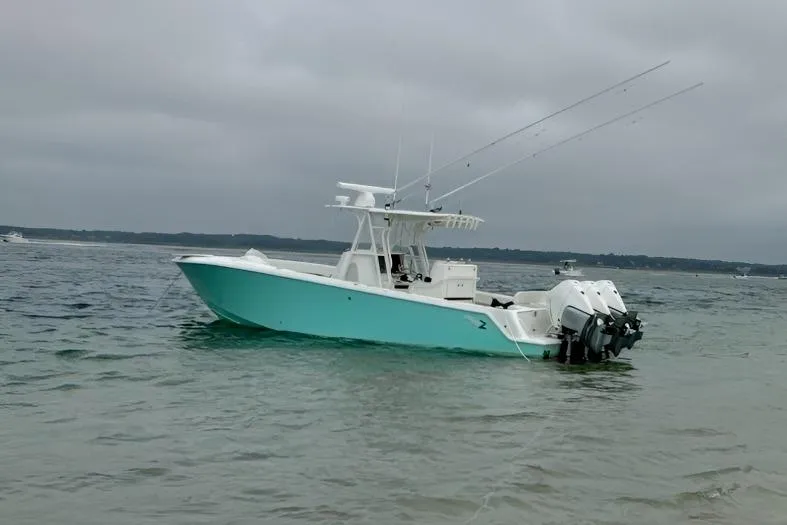 The Image of 2015 SeaVee 340Z boat with dual engines on calm water under cloudy sky. - 0