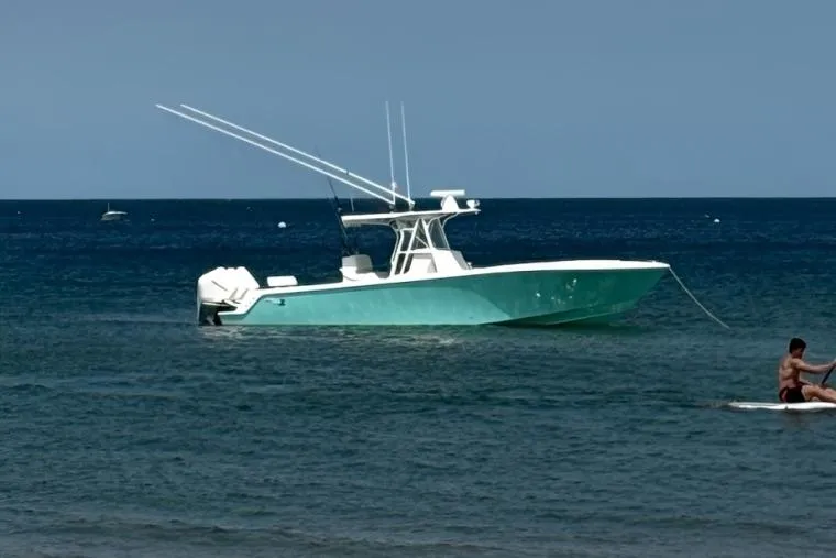 Slide: The Image of 2015 SeaVee 340Z boat anchored in calm ocean waters. - 1