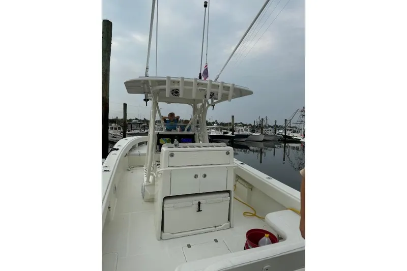 Slide: The Image of 2015 SeaVee 340Z boat docked at marina, featuring spacious deck and modern design. - 9