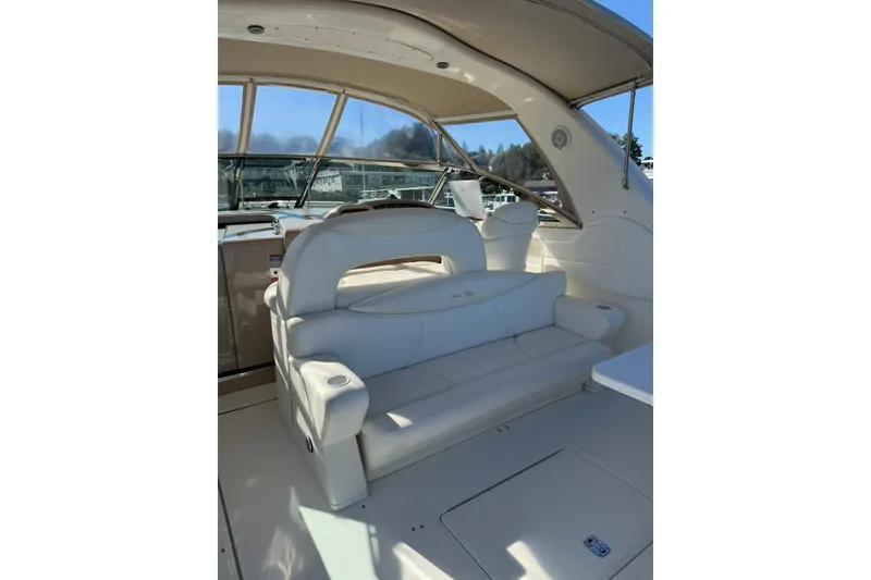 Slide: The Image of 2000 Sea Ray 410 Express Cruiser interior with white seating and helm station. - 11