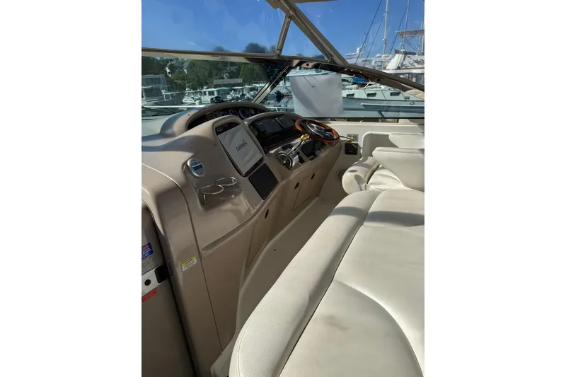 Slide: The Image of 2000 Sea Ray 410 Express Cruiser helm with leather seating and navigation equipment. - 21