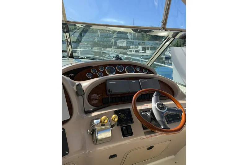 Slide: The Image of Cockpit of 2000 Sea Ray 410 Express Cruiser with steering wheel and control panel. - 24
