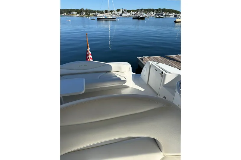 Slide: The Image of 2000 Sea Ray 410 Express Cruiser docked in serene marina with scenic view. - 31