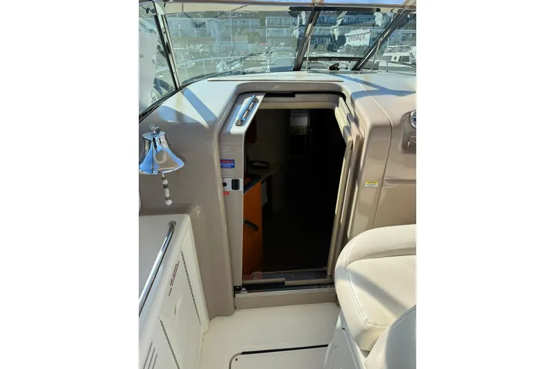 Slide: The Image of 2000 Sea Ray 410 Express Cruiser cabin entrance with bell and seating area. - 41