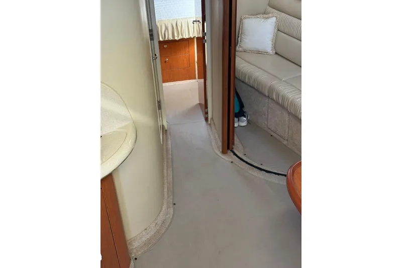 Slide: The Image of Interior of 2000 Sea Ray 410 Express Cruiser, featuring seating and cabin area. - 43