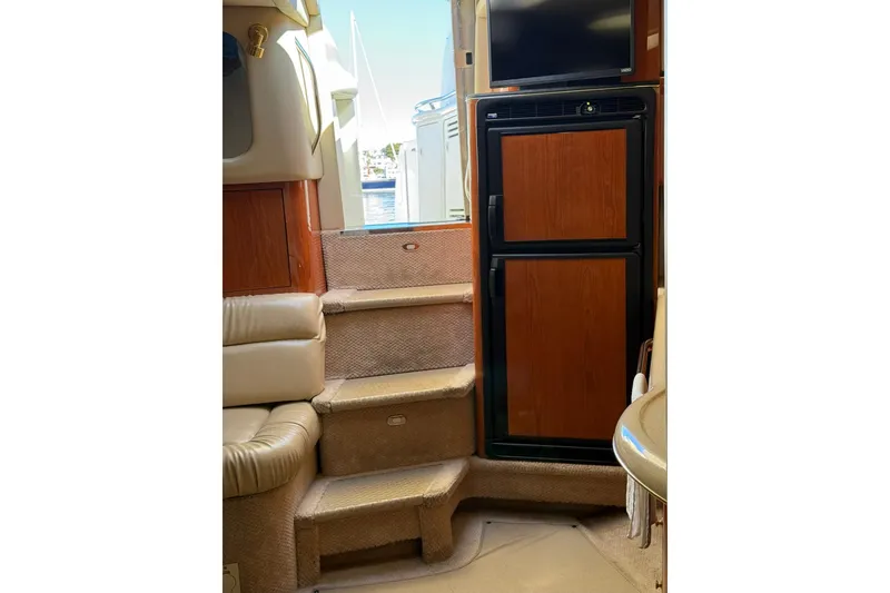 Slide: The Image of Interior of 2000 Sea Ray 410 Express Cruiser with steps and wooden cabinetry. - 53