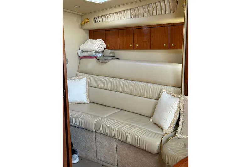 Slide: The Image of Luxurious interior of 2000 Sea Ray 410 Express Cruiser with plush seating and elegant decor. - 54