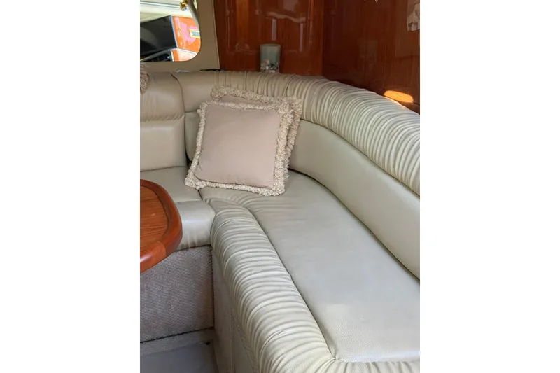 Slide: The Image of Luxurious interior of 2000 Sea Ray 410 Express Cruiser with plush seating and cushion. - 60
