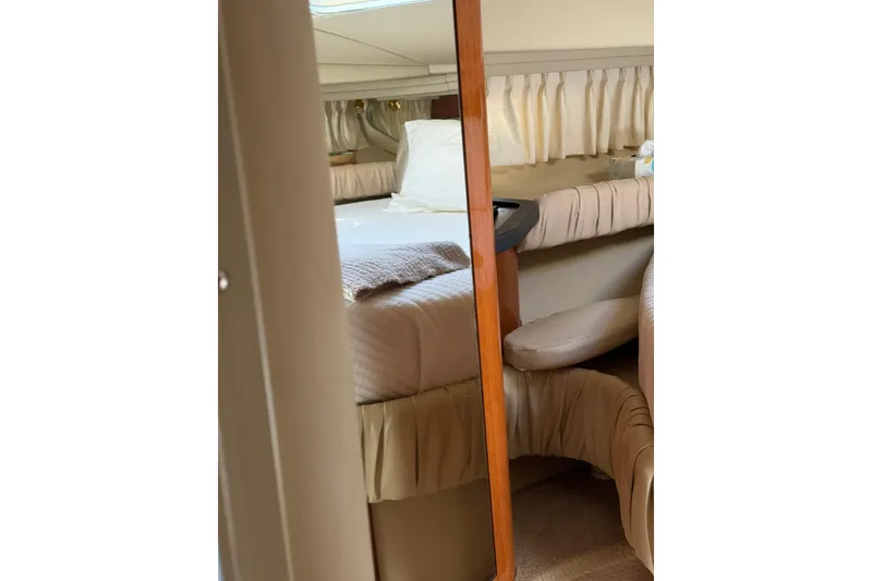 Slide: The Image of Interior of 2000 Sea Ray 410 Express Cruiser with cozy bed and elegant decor. - 65