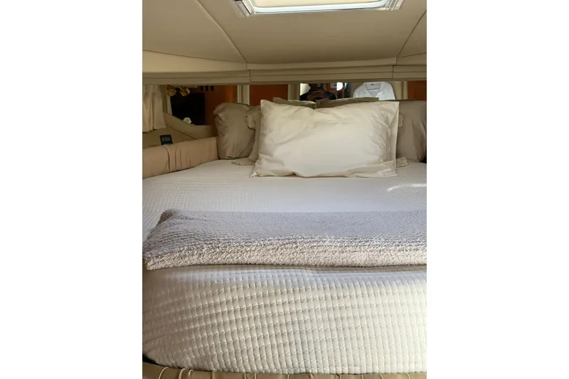 Slide: The Image of Luxurious cabin interior of 2000 Sea Ray 410 Express Cruiser with plush bedding. - 66