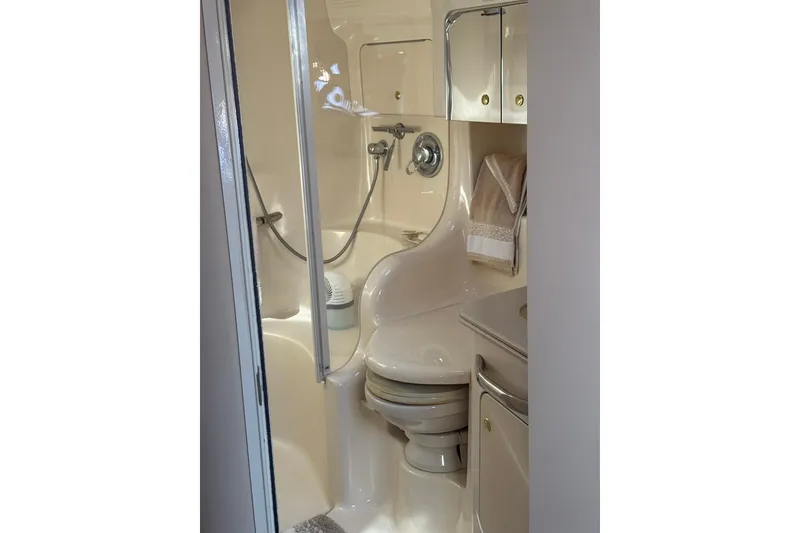 Slide: The Image of Bathroom interior of 2000 Sea Ray 410 Express Cruiser, featuring shower and toilet. - 73