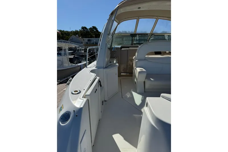 Slide: The Image of 2000 Sea Ray 410 Express Cruiser interior with white seating and open deck view. - 9