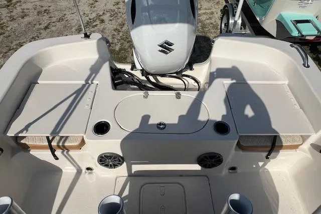 Slide: The Image of 2026 Carolina Skiff 19 LS boat interior with Suzuki engine, featuring seating and storage compartments. - 3