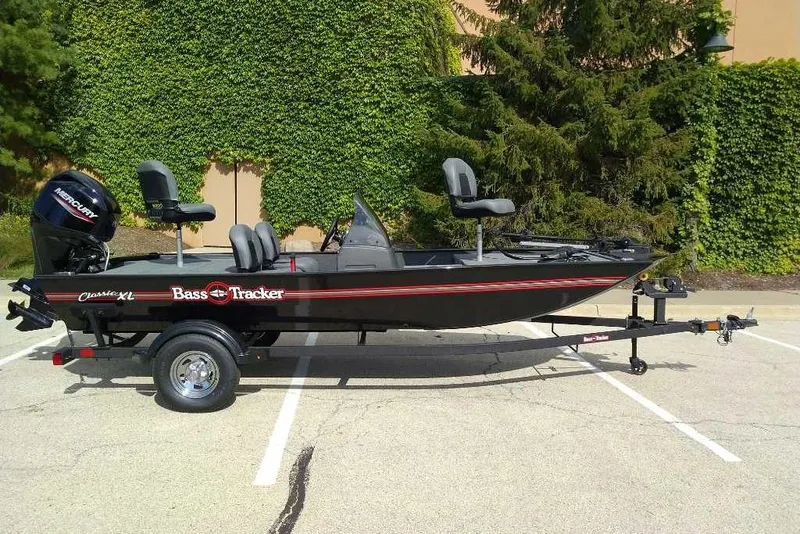 The Image of 2026 Tracker Bass Tracker Classic XL boat on trailer, parked outdoors. - 0