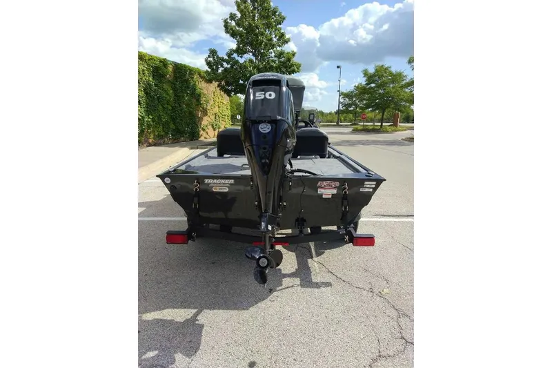 Slide: The Image of 2026 Tracker Bass Tracker Classic XL boat with 50 HP motor in parking lot. - 3
