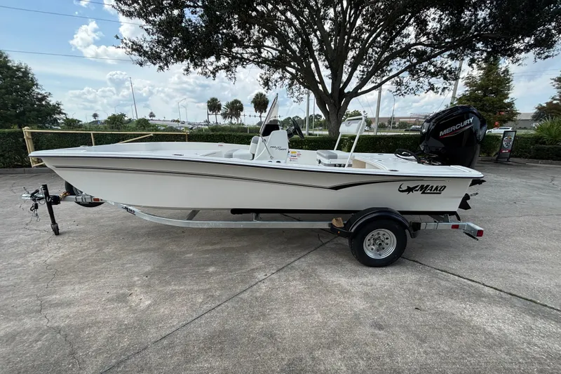Slide: The Image of 2026 Mako Pro Skiff 17 CC boat on trailer, parked outdoors. - 48