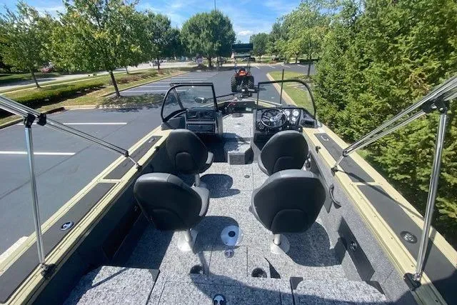 Slide: The Image of 2026 Tracker Targa V-18 Combo boat interior with seating and steering console. - 6