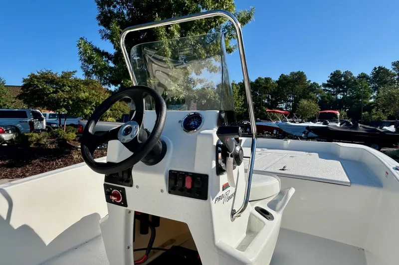 The Image of 2026 Mako Pro Skiff 17 CC boat on trailer in parking lot. - 0