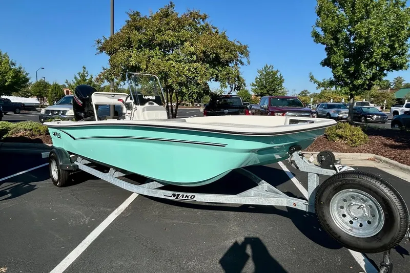 Slide: The Image of 2026 Mako Pro Skiff 17 CC boat console with steering wheel and controls. - 1