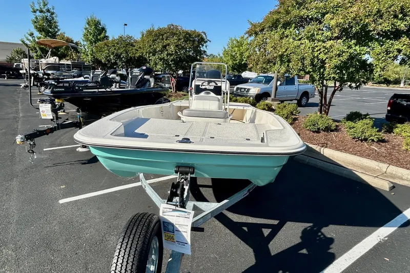 Slide: The Image of 2026 Mako Pro Skiff 17 CC boat on trailer in parking lot, sunny day. - 3