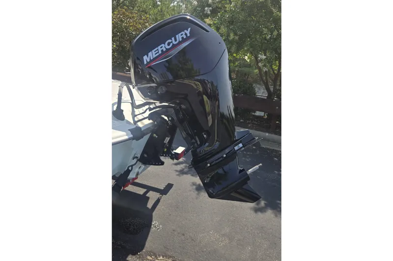 Slide: The Image of 2026 Mako Pro Skiff 17 CC with Mercury outboard motor in sunlight. - 56