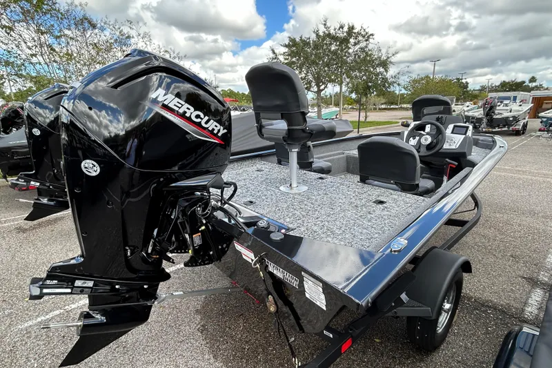 Slide: The Image of 2026 Tracker Pro Team 175 Crappie Edition boat with Mercury engine in parking lot. - 2