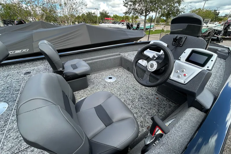 Slide: The Image of 2026 Tracker Pro Team 175 Crappie Edition boat interior with steering wheel and seating. - 5