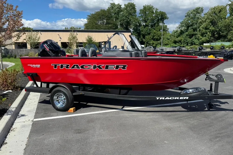 The Image of Red 2026 Tracker Pro Guide V-175 WT boat on trailer in parking lot. - 0