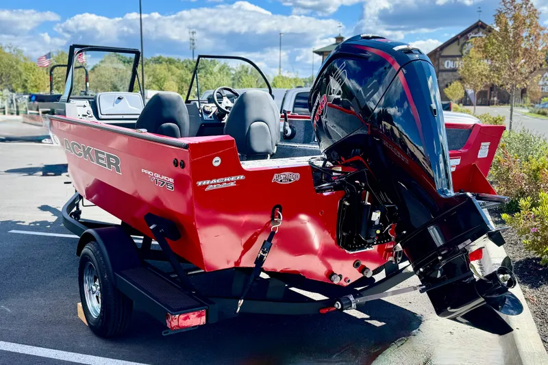 Slide: The Image of 2026 Tracker Pro Guide V-175 WT boat with powerful outboard motor, parked outdoors. - 2