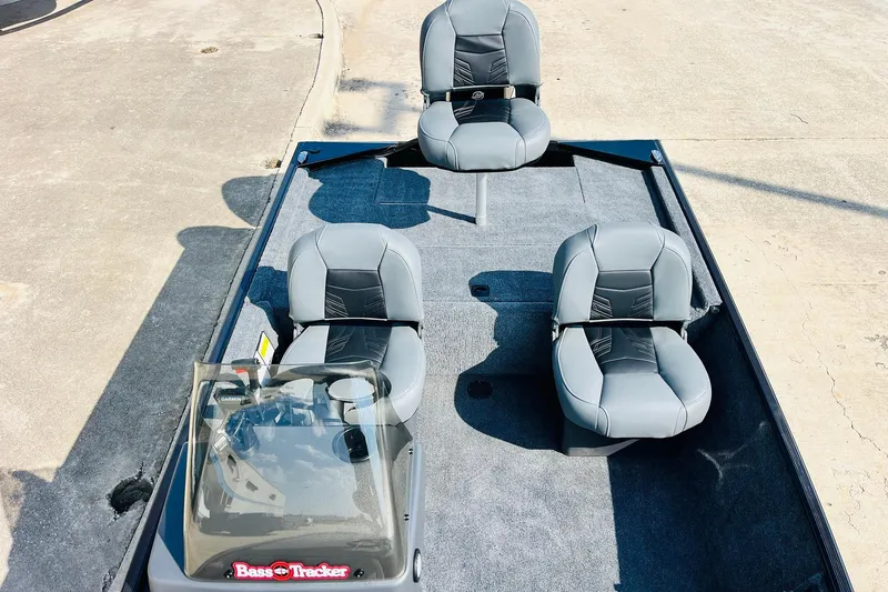Slide: The Image of 2026 Tracker Bass Tracker Classic XL boat interior with four gray seats. - 16