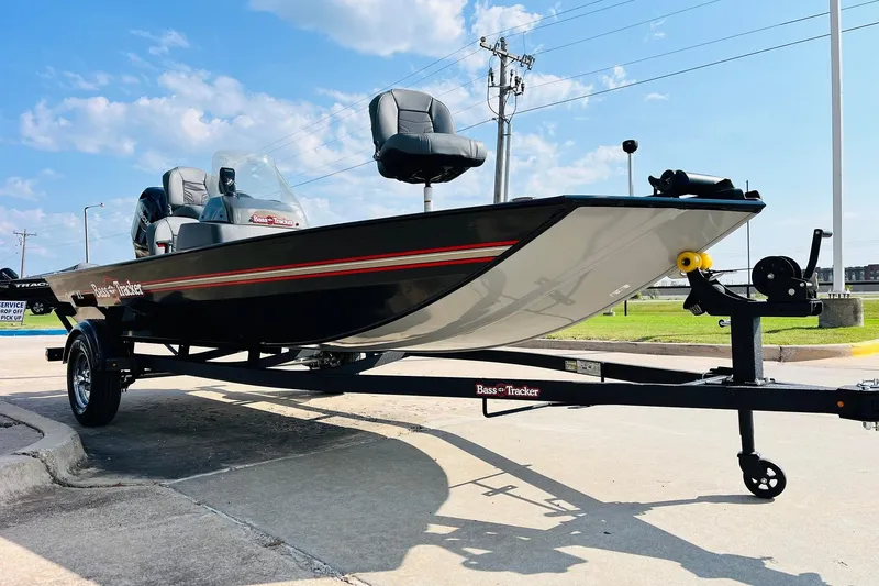 Slide: The Image of 2026 Tracker Bass Tracker Classic XL boat on trailer, parked outdoors under blue sky. - 2