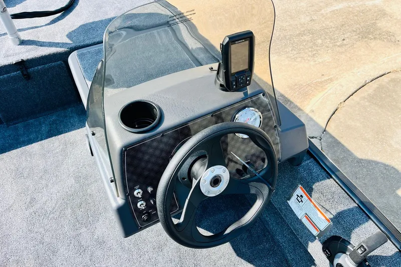 Slide: The Image of 2026 Tracker Bass Tracker Classic XL boat dashboard with steering wheel and navigation system. - 21