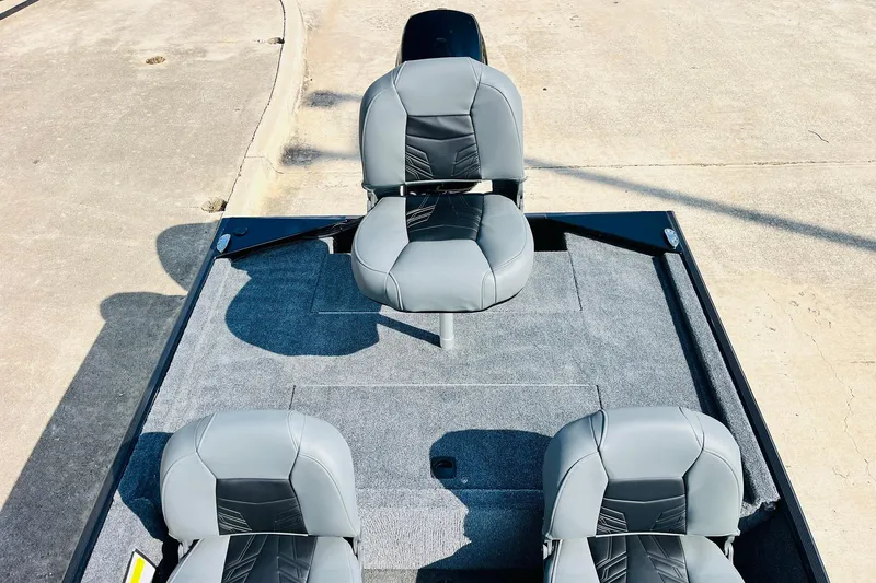 Slide: The Image of 2026 Tracker Bass Tracker Classic XL boat seats on a carpeted deck. - 23