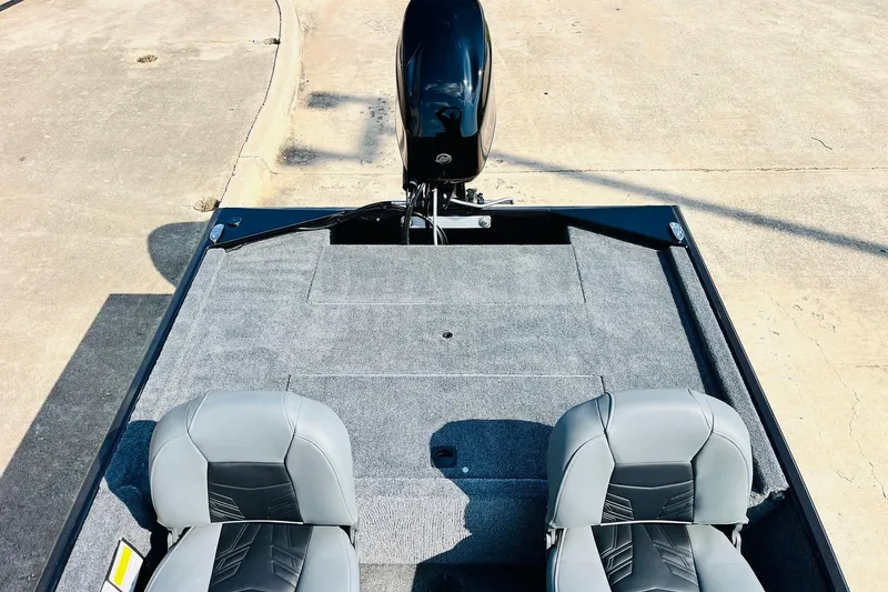 Slide: The Image of 2026 Tracker Bass Tracker Classic XL boat interior with gray seats and carpeted deck. - 24