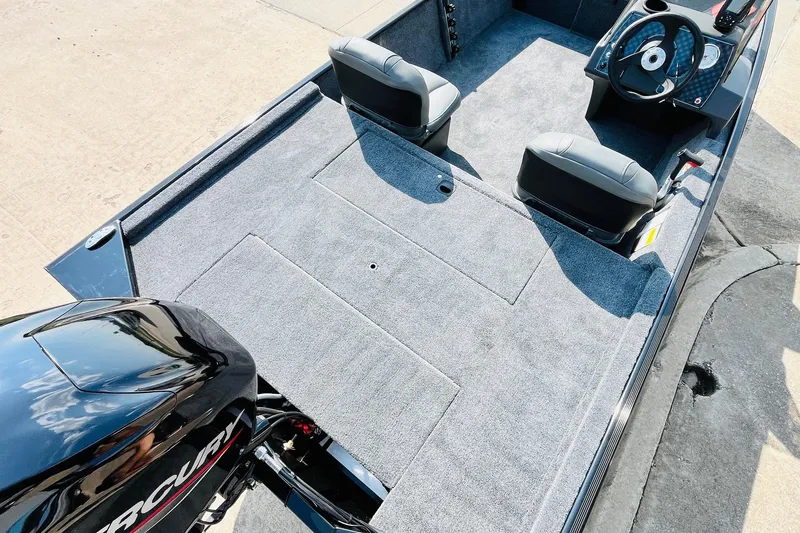 Slide: The Image of 2026 Tracker Bass Tracker Classic XL boat interior with carpeted deck and dual seats. - 28