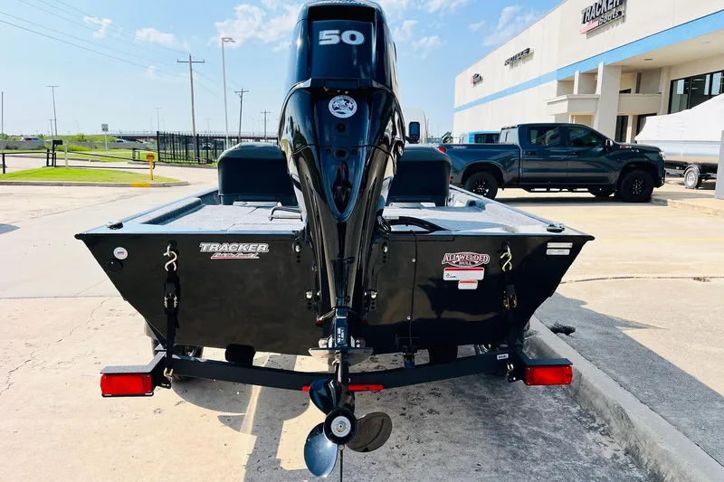 Slide: The Image of 2026 Tracker Bass Tracker Classic XL boat with powerful outboard motor, parked outdoors. - 5