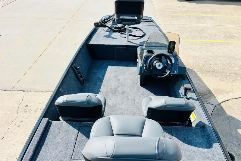 Slide: The Image of 2026 Tracker Bass Tracker Classic XL boat interior with steering console and seating. - 7